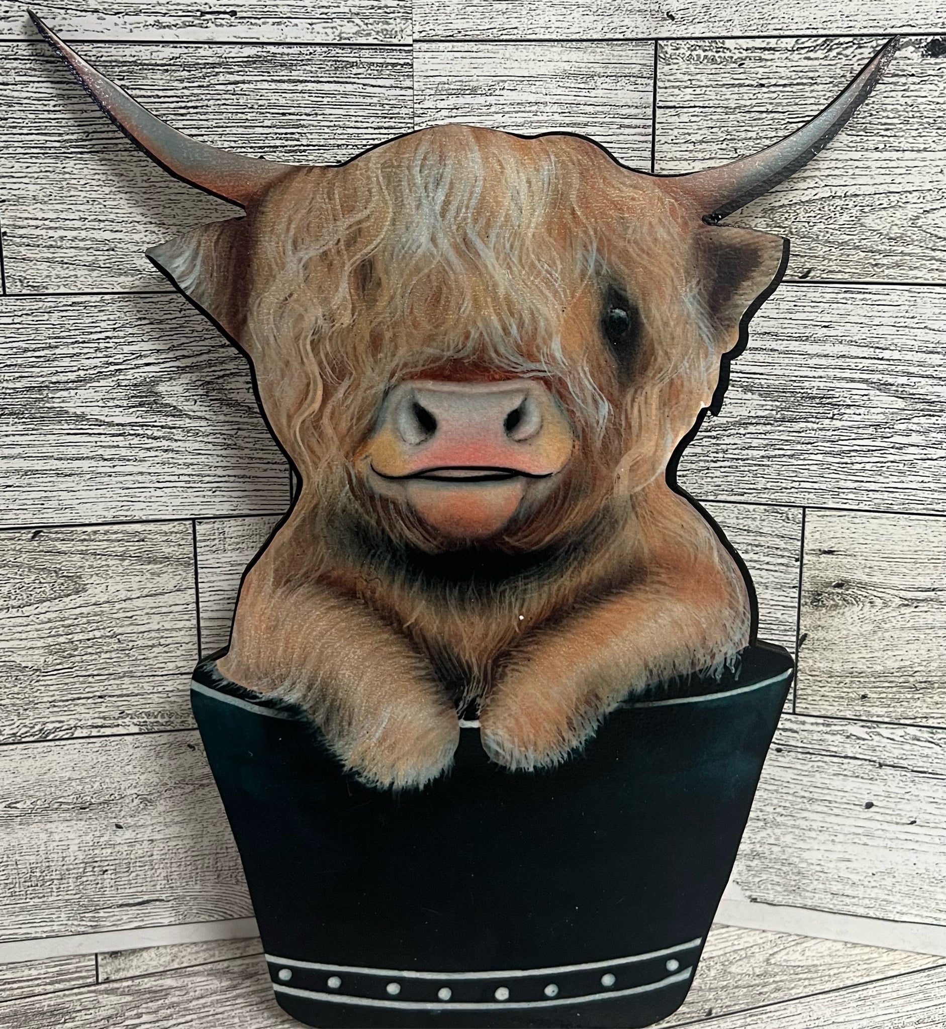 Highland cow cartoon in a bucket
